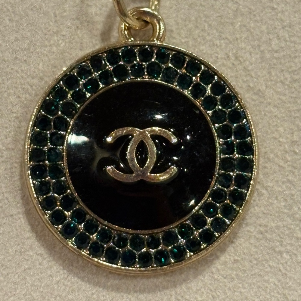 CHANEL CC Black and Gold Circle Charm with stones